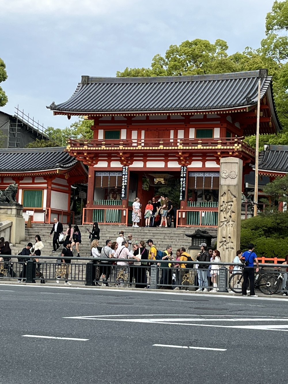 The red romon gate of Yasaka Shrine in the Gion district of Kyoto with a crowd of visitors