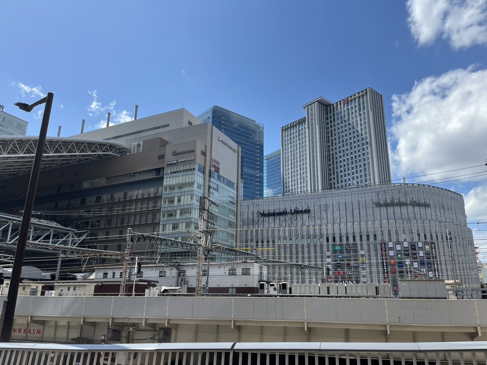 The Umeda district skyline around Osaka Station with the Yodobashi Umeda building under a blue sky